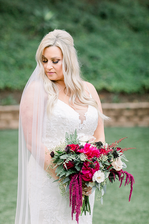  bride in a white lace mermaid style gown and a strapless neckline 