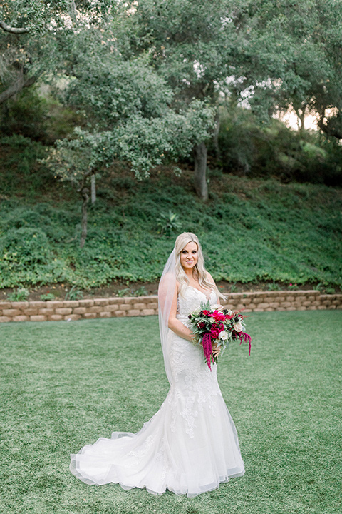  bride in a white lace mermaid style gown and a strapless neckline 