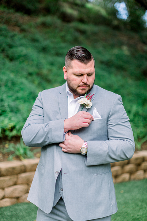  and groom in a light grey suit at the ceremony