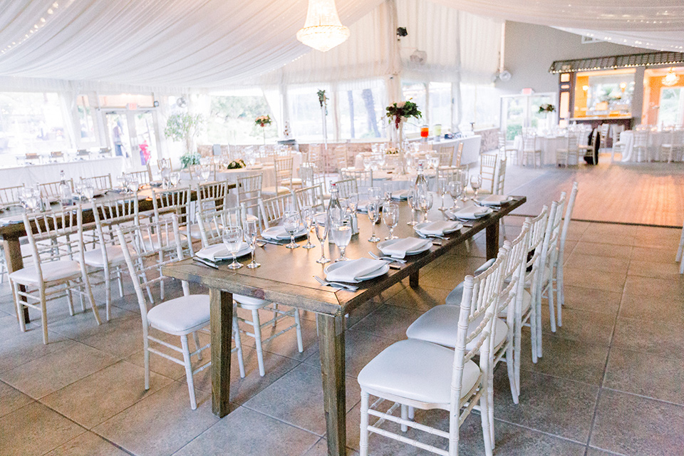  reception tables with white linens and farmhouse tables