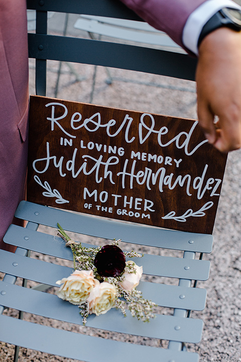  groom in a rose suit with a floral bow tie