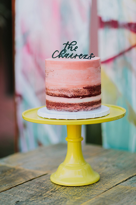  pink ombre cake with blue décor on a yellow stand