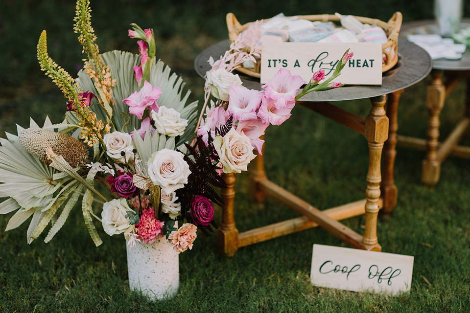  bohemian colorful flowers with palm leaves and wooden tables 