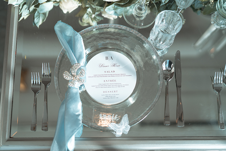  glass table with blue and silver flatware