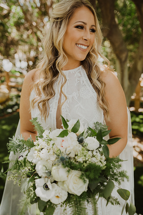  the bride in a flowing white gown with a high lace neckline and a long cathedral veil