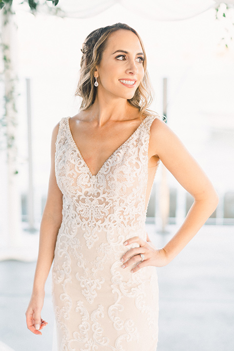  bride in an ivory lace gown with a modern geometric pattern and a v neckline 