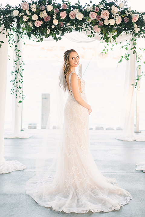  bride in an ivory lace gown with a modern geometric pattern and a v neckline 