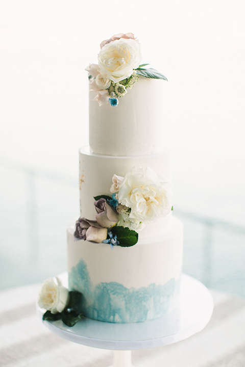  white and blue ombre cake with white floral design