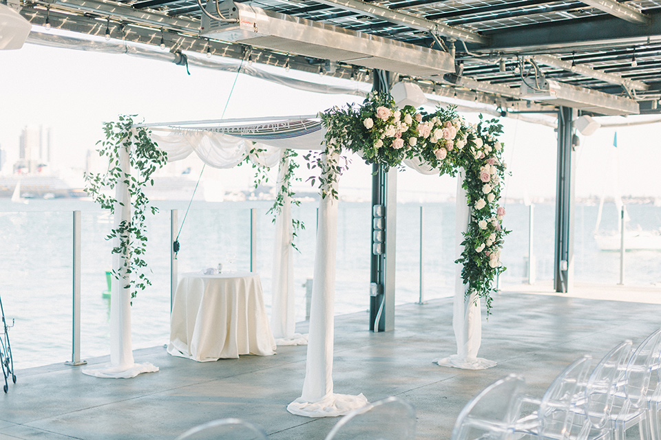  ceremony space with white and clear details and ceremony arch