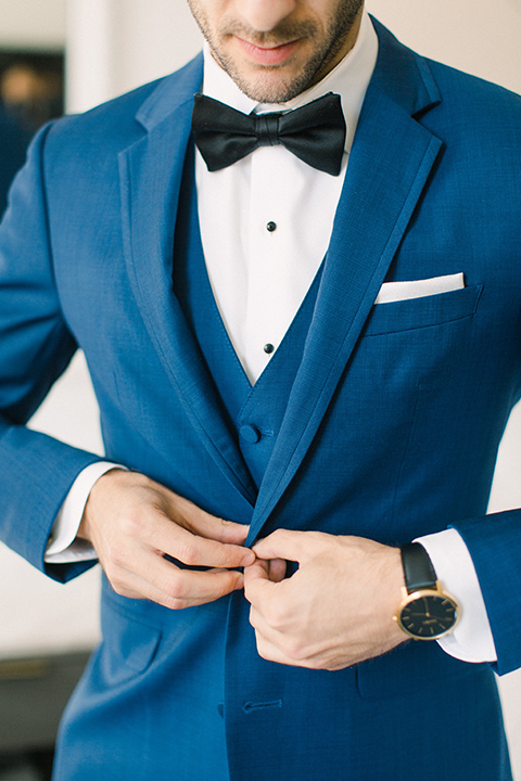  groom close up with a cobalt suit with a black bow tie