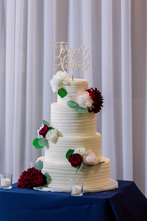  white cake with red and white flowers 