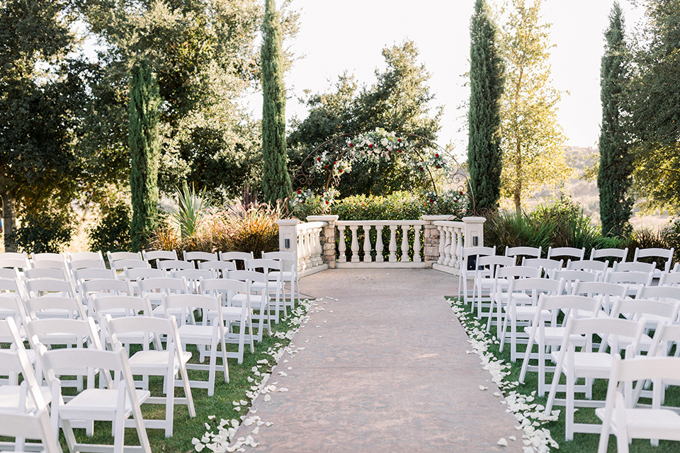  white chairs and white gazebo wedding ceremony decor