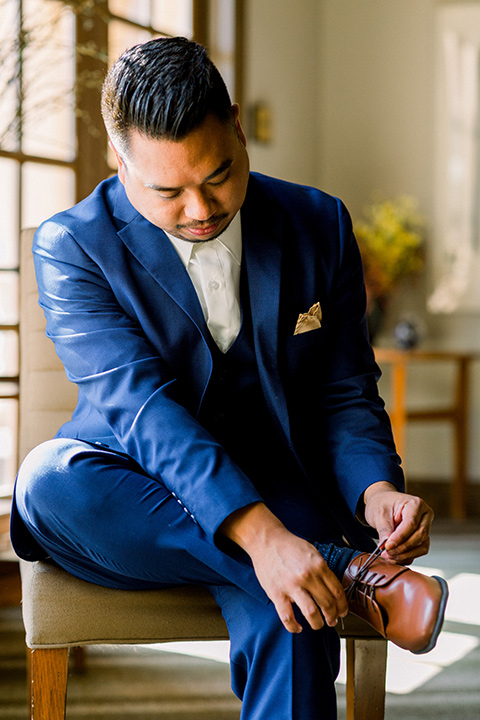  groom in a cobalt blue suit with a brown shoes 