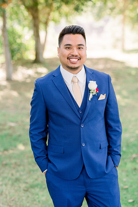  groom in a cobalt blue suit with a pink long tie 