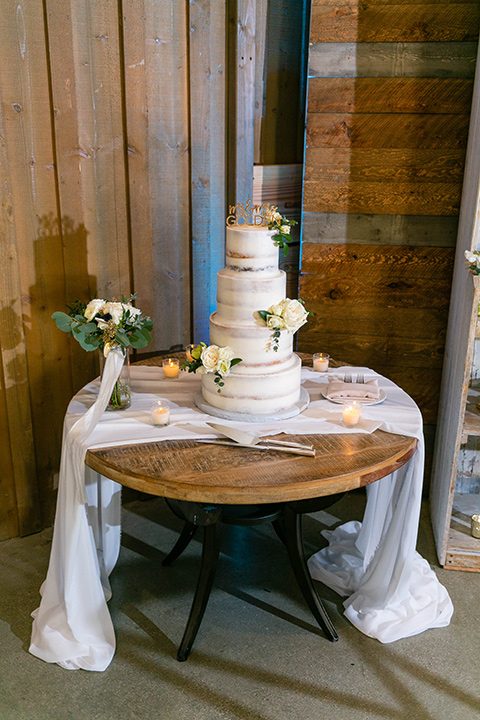  cake with white icing and white florals