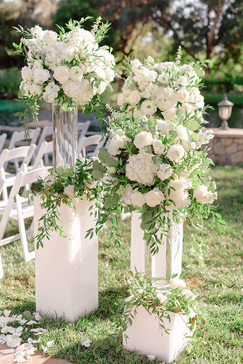  white floral décor on the ceremony arch