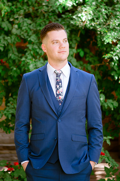  groom in a cobalt blue suit with a blue floral long tie 