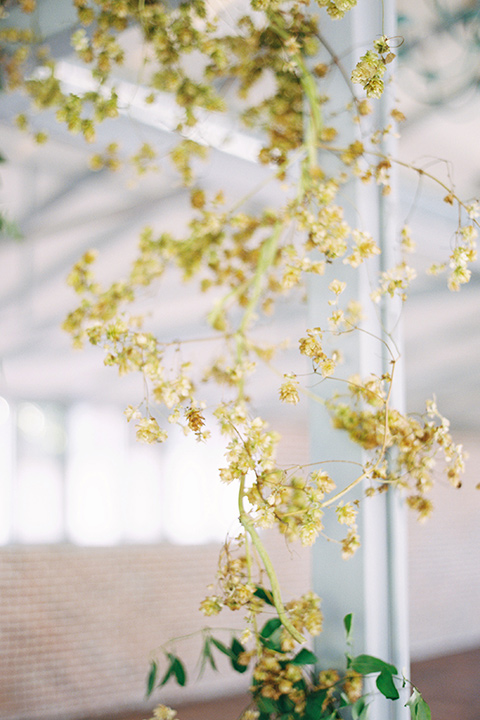  arch at ceremony with green and yellow flowers 