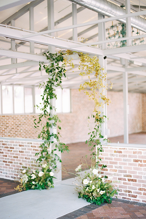  ceremony arch with green and yellow flowers