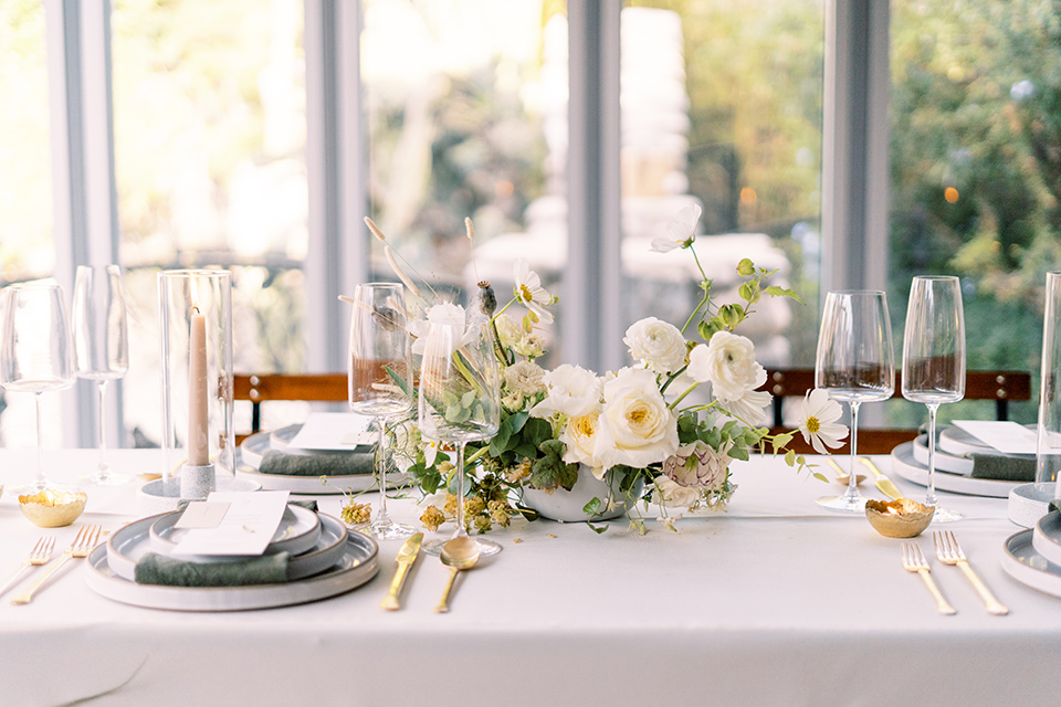  white table and table linens with sunset flowers 