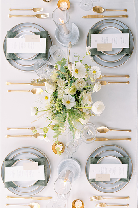  white linens with silver plate chargers and gold flatware 