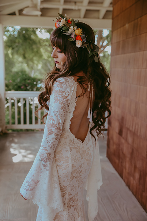 bride in a lace bohemian gown with tulip sleeves and a braided crown