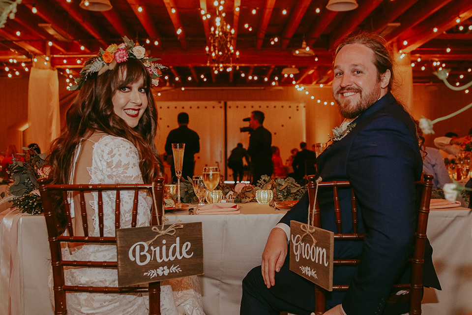  bride in a lace bohemian gown with tulip sleeves and a braided crown, the groom in a cobalt blue suit for purchase 