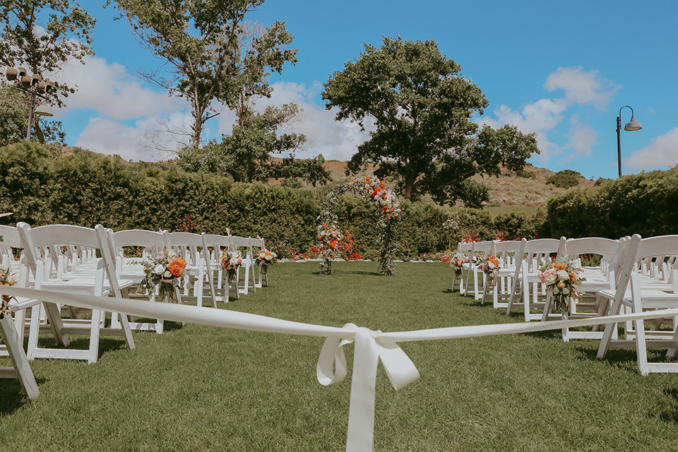  ceremony décor with chairs and bright colored florals 