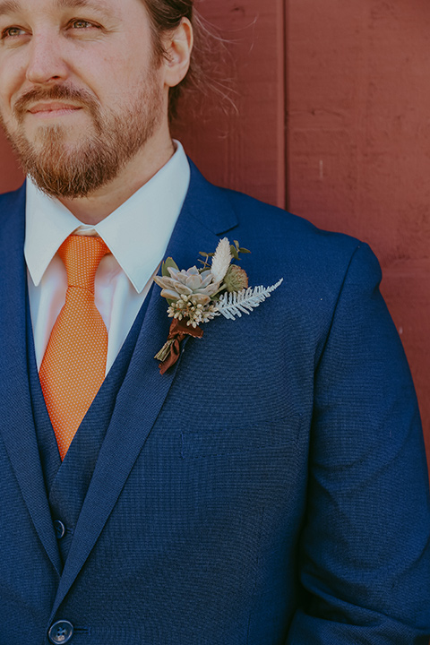  groom in a cobalt blue suit for purchase with a burnt orange tie 