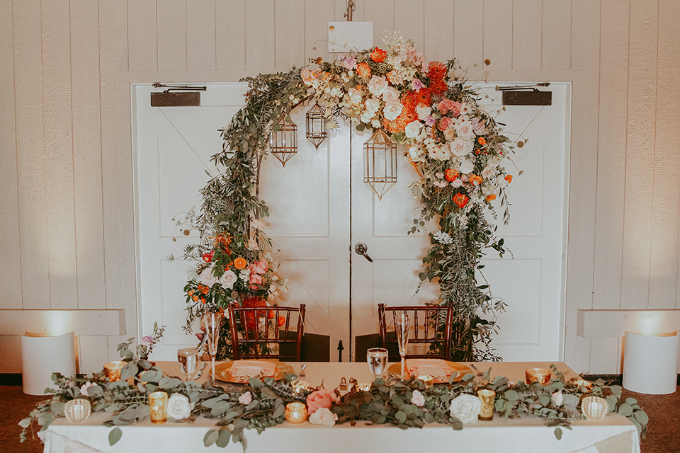  sweetheart table with wooden and floral decor 