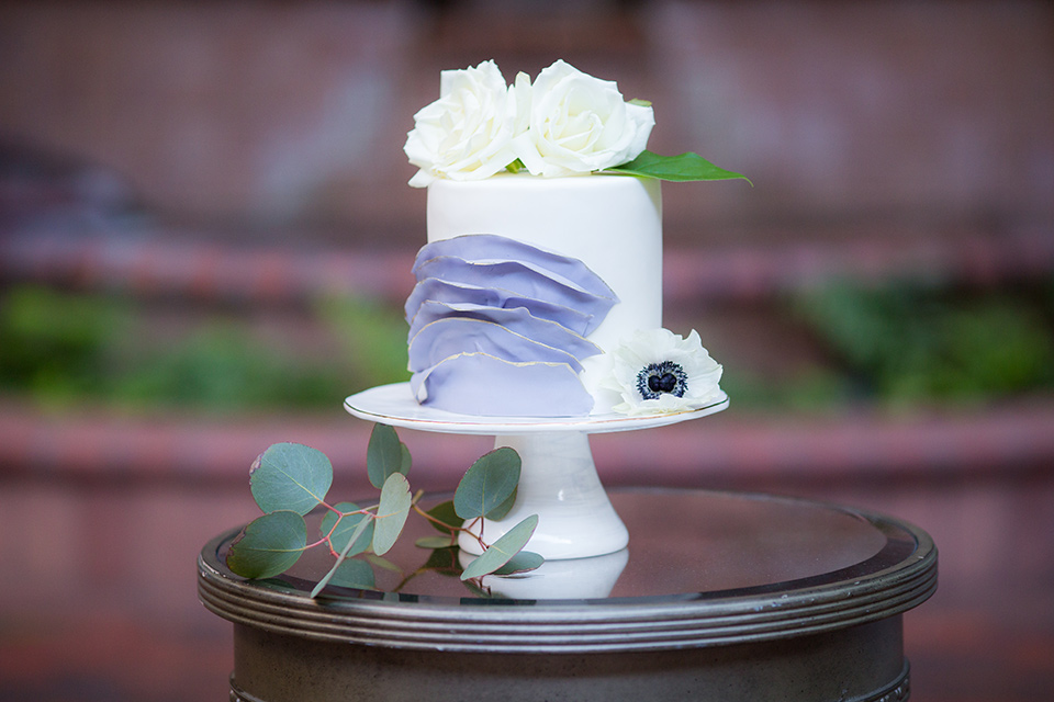  white and lilac colored cake with flowers on it