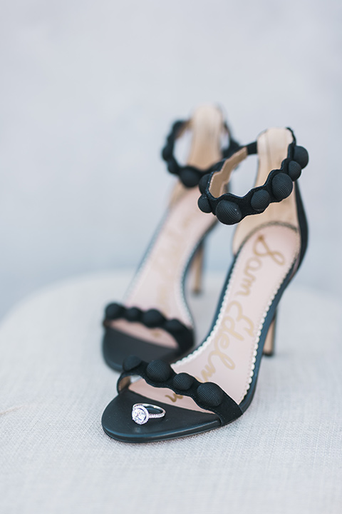 black bridal shoes with ruffle detailing on the straps