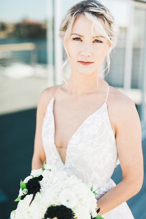 bride in a white gown with a deep v neckline and thin straps