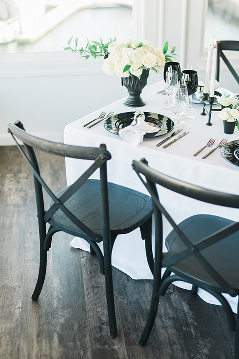 white table linens with black farmhouse style chairs