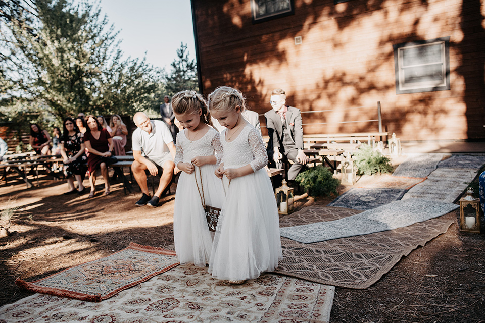  flower girls walking down the aisle 