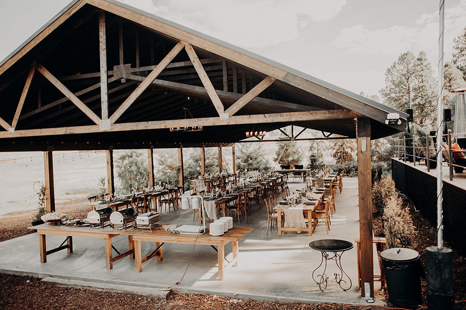  wedding reception under an outdoor gazebo with bohemian details