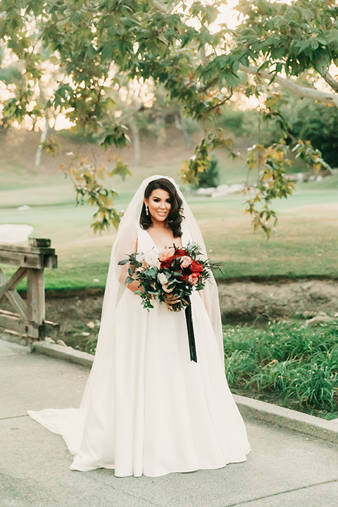  ride in a white ballgown with a plunging neckline and long veil a 