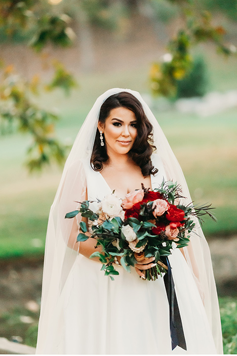  ride in a white ballgown with a plunging neckline and long veil 