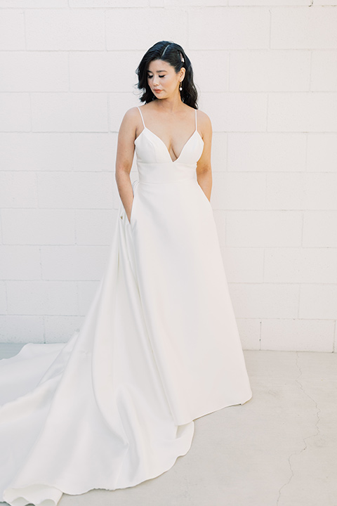  bride in a white modern ballgown with pockets and a low cut neckline 