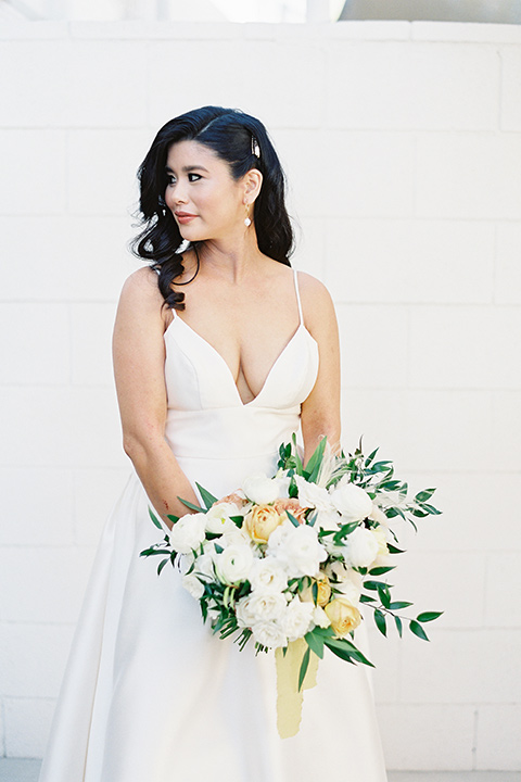  bride in a white modern ballgown with pockets and a low cut neckline