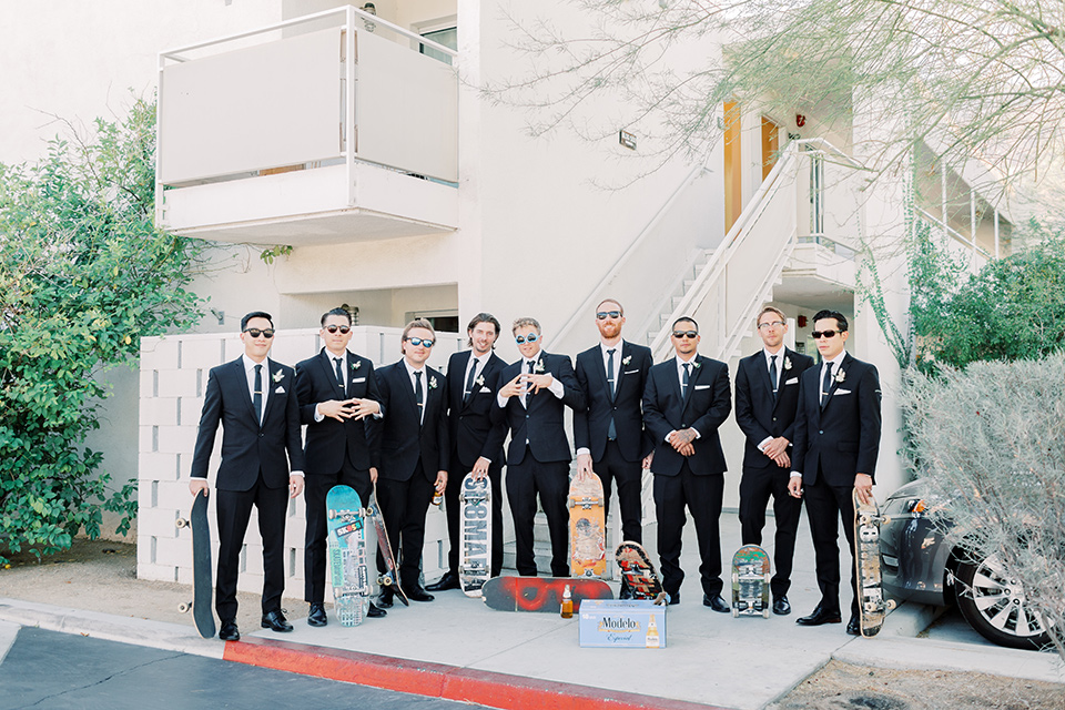  groom and groomsmen in black tuxedos and black bow ties