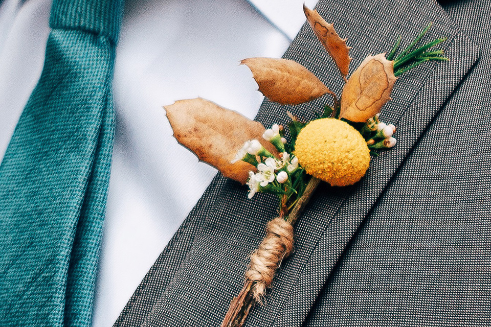  the groom in a café brown suit a dusty teal long tie 