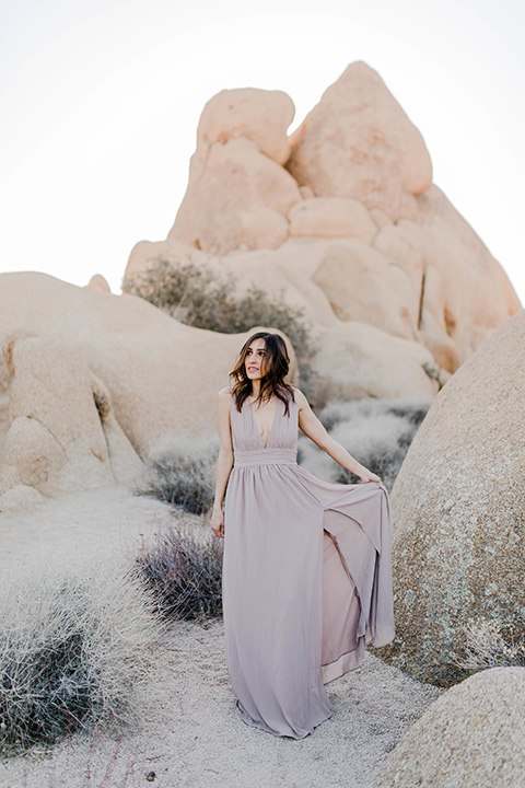  bride in a taupe colored maxi dress with straps and her hair down 