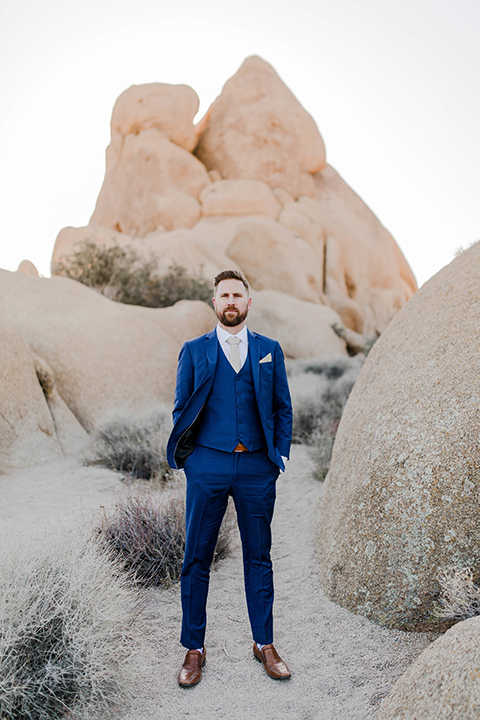  groom in a cobalt blue suit with a neutral long tie 