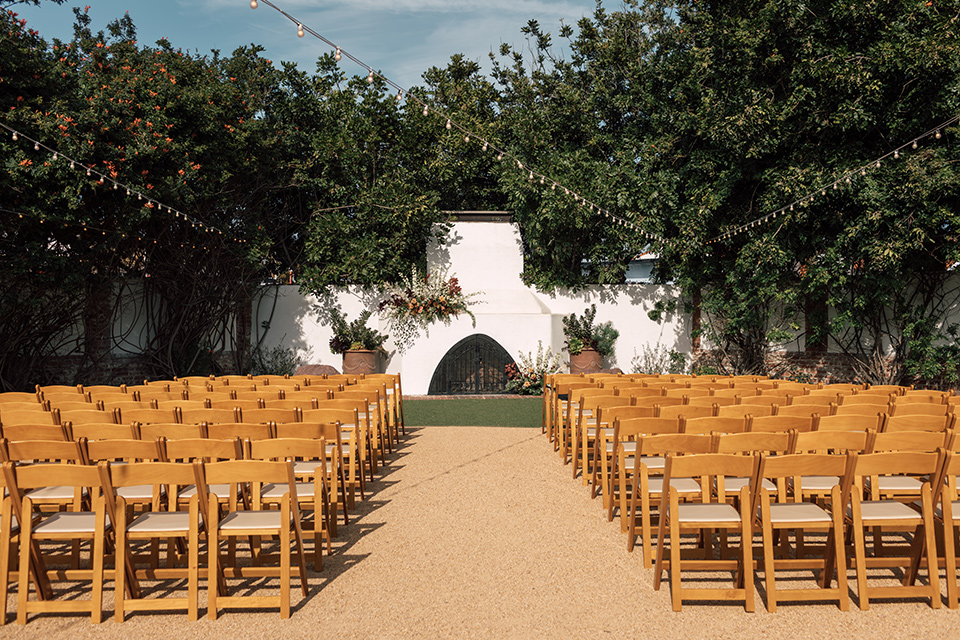 wooden chairs with a white brick backdrop