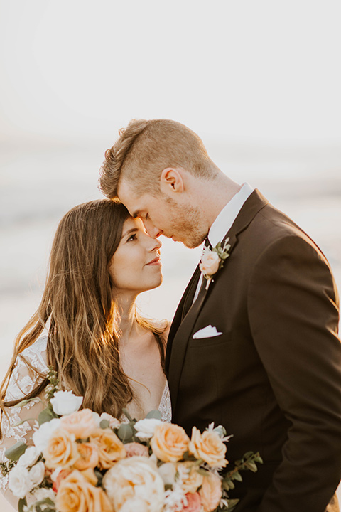  bride in a flowing ballgown and the groom in a black suit 