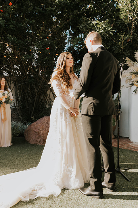  bride in a flowing ballgown and the groom in a black suit 