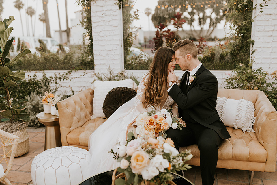  bride in a flowing ballgown and the groom in a black suit 