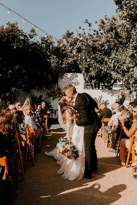  bride in a flowing ballgown and the groom in a black suit