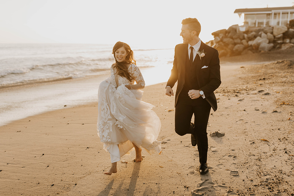  bride in a flowing ballgown and the groom in a black suit, 